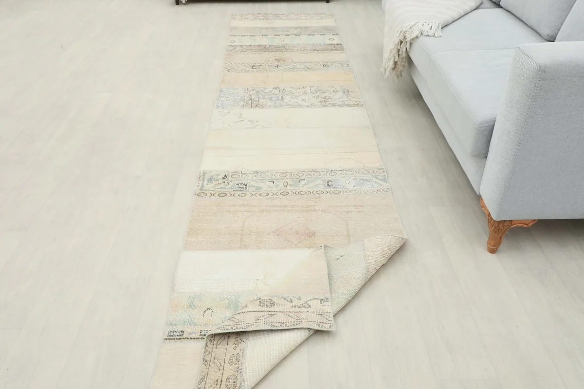 Runner partially rolled up in a room, demonstrating its flexibility and construction.