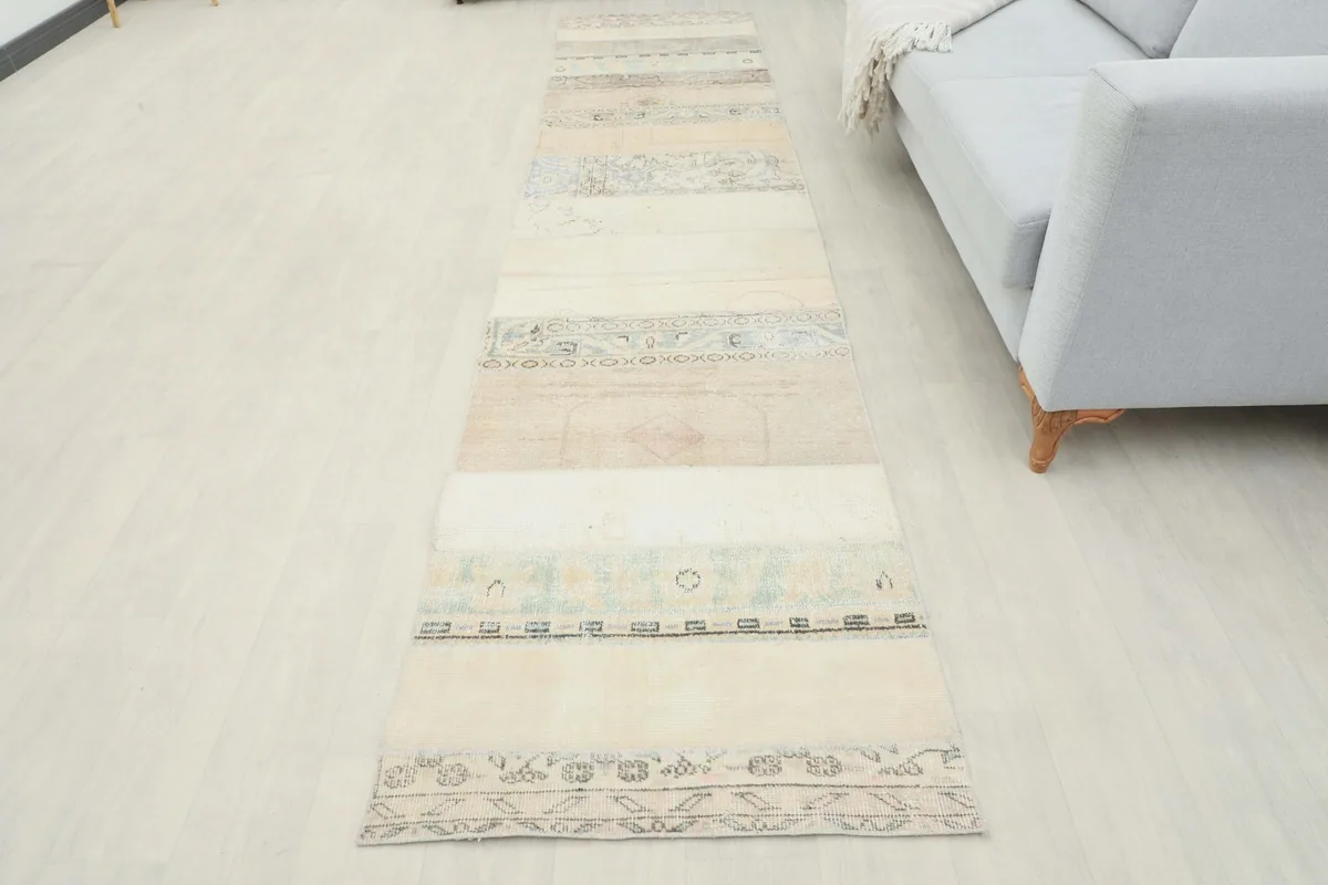 Full overhead view of the vintage patchwork runner in a room, showcasing its overall design and length.