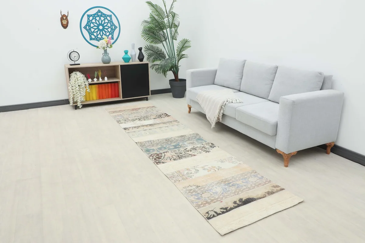 Vintage patchwork runner rug in a modern living room setting with a light gray sofa