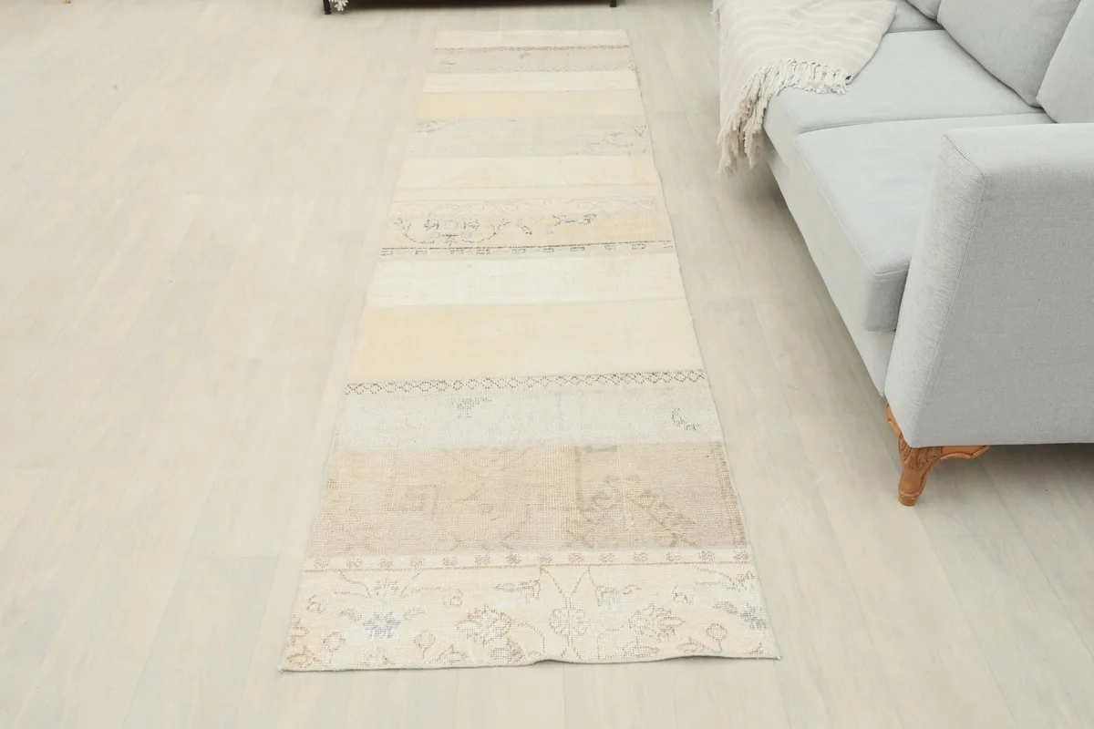 Full length view of the cream and beige runner rug in a room setting, showcasing its proportions