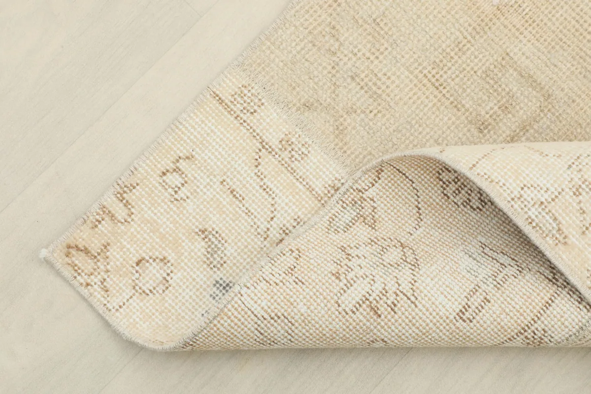 Close-up of the rug's backside, revealing the cotton foundation and hand-knotted construction
