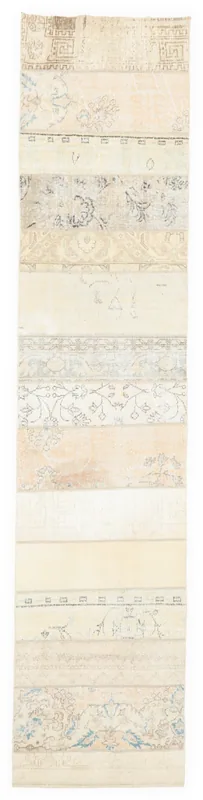 Full overhead view of a beige patchwork vintage runner rug on a white background