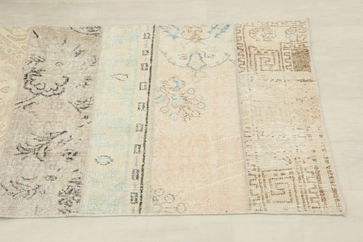 Detailed view of various beige and light blue patches with geometric and floral patterns