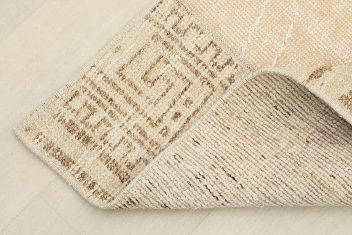 Underside view of the rug showing the hand-knotted cotton foundation