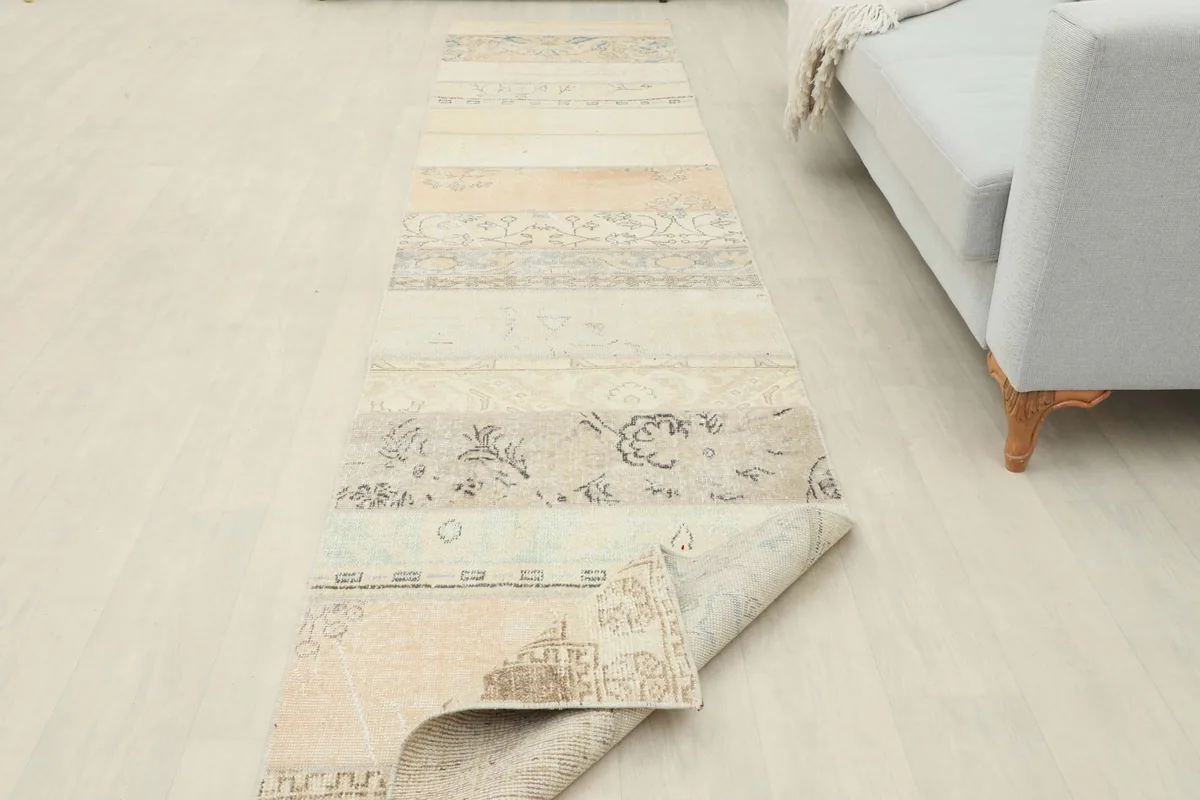 Runner rug partially folded, showcasing its flexibility and length in a room