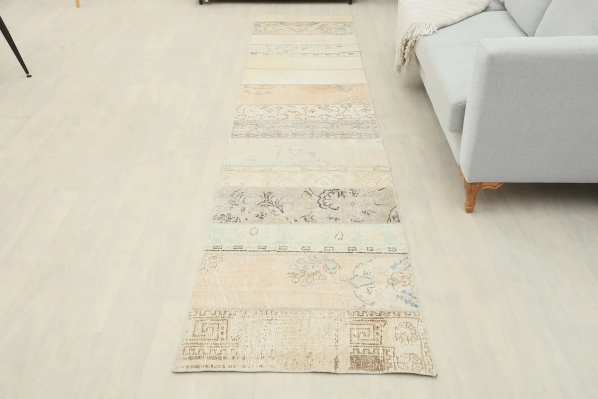 Overhead view of the beige patchwork runner rug laid out in a modern room