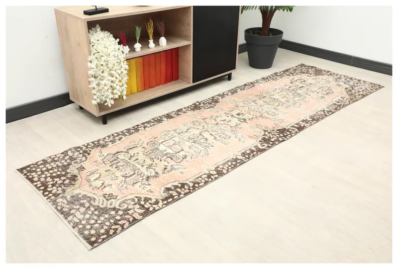 Full top view of the 2'8" x 9'2" vintage Anatolian runner with rose field and brown border