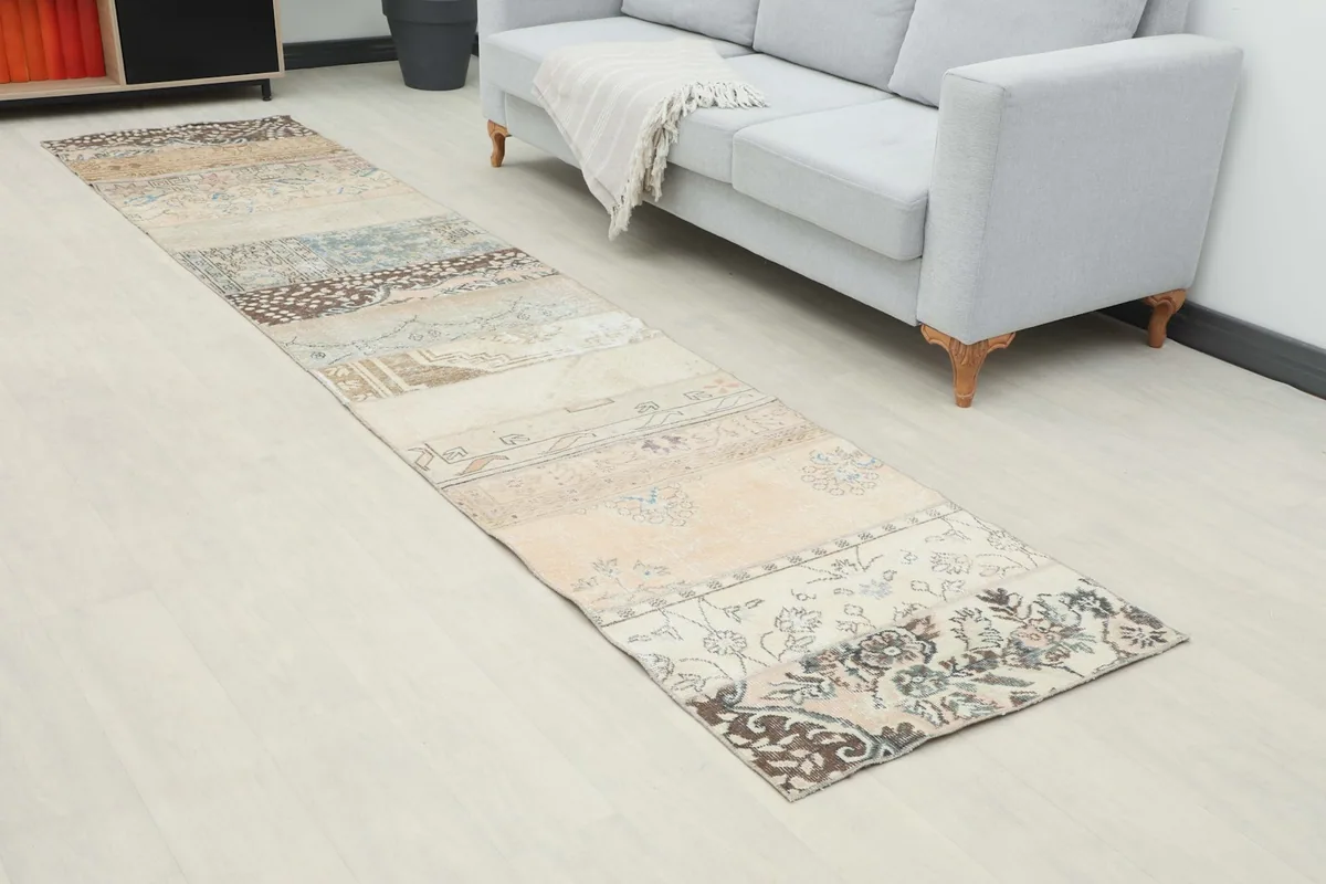 Angled view of the patchwork runner rug in a modern living space with a sofa