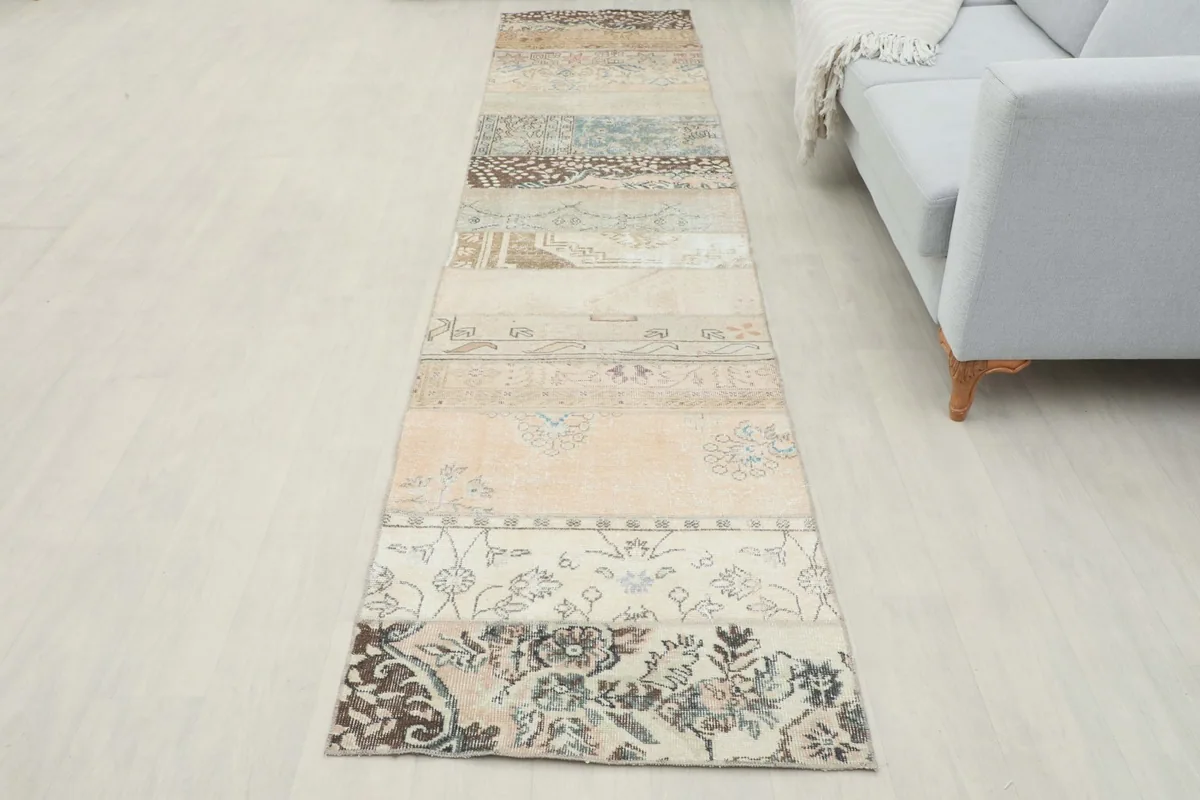 Full length view of the runner rug in a room, showcasing its unique patchwork design