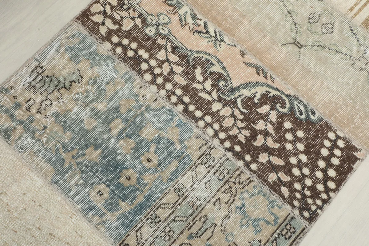 Detailed view of the blue, brown, and beige patchwork sections with varied patterns