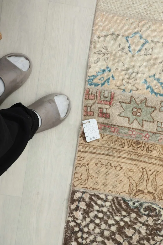 Overhead view of a section of the runner with feet for scale, showing various patterns