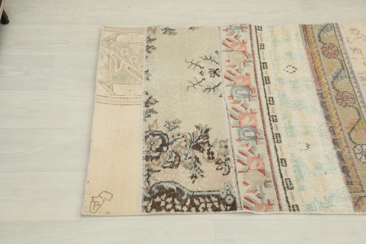 Close-up of another section of the patchwork runner with beige, brown, and pink motifs