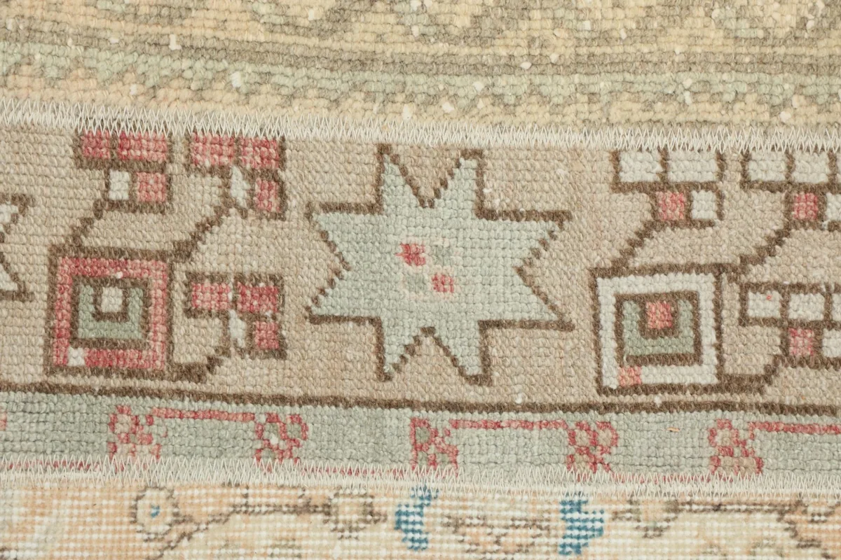 Close-up of the low wool pile and intricate geometric motifs on the vintage runner
