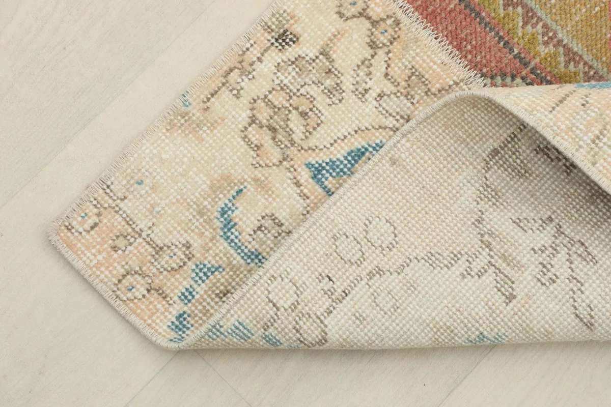 Corner of the runner folded to show the hand-knotted wool pile and cotton foundation