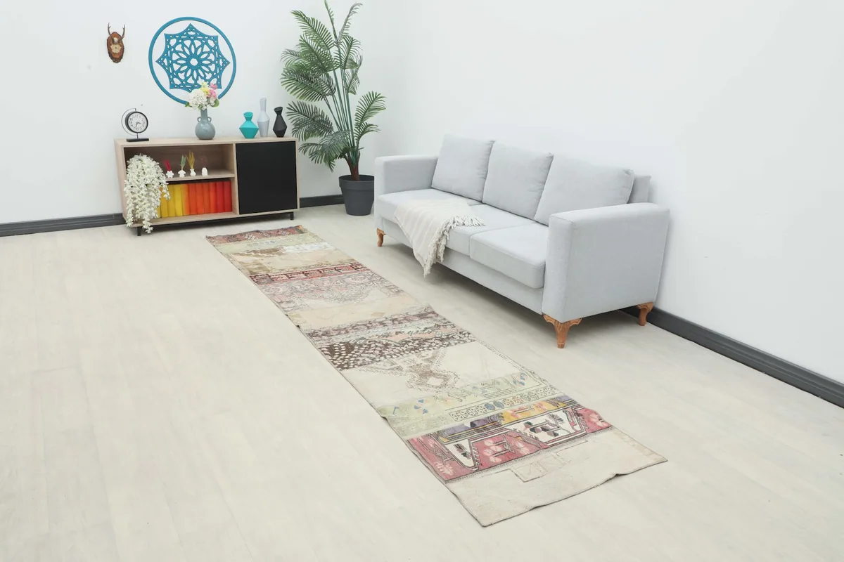 Beige patchwork runner displayed in a modern living space with a light gray sofa