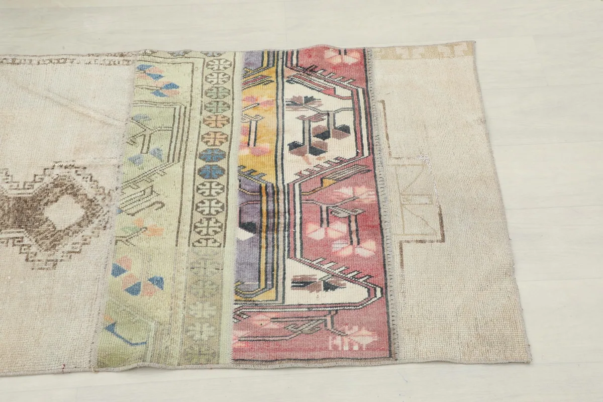 Close-up view of one end of the runner, highlighting rust, purple, and green geometric patterns