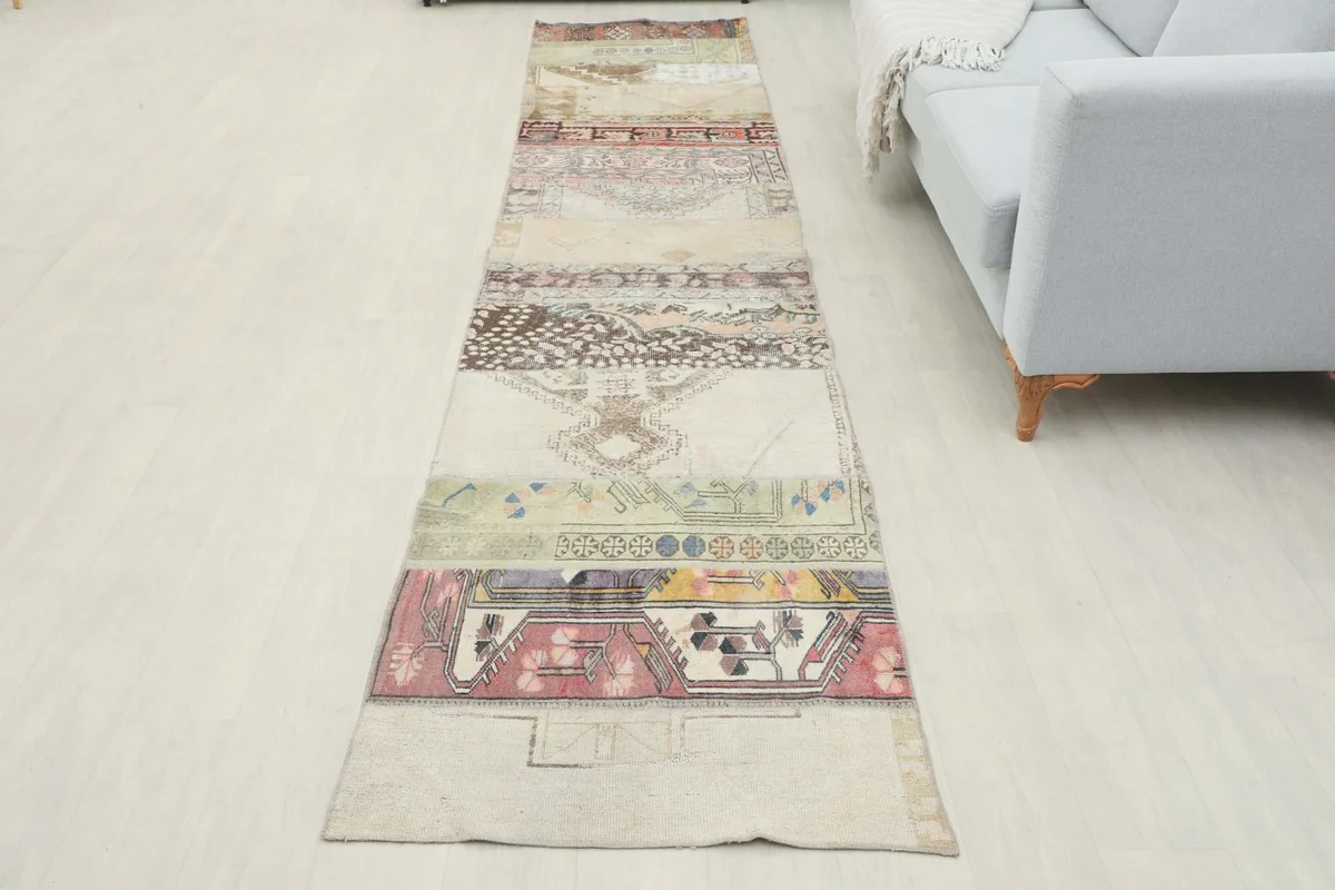 Full overhead view of the beige patchwork runner in a room setting, next to a sofa