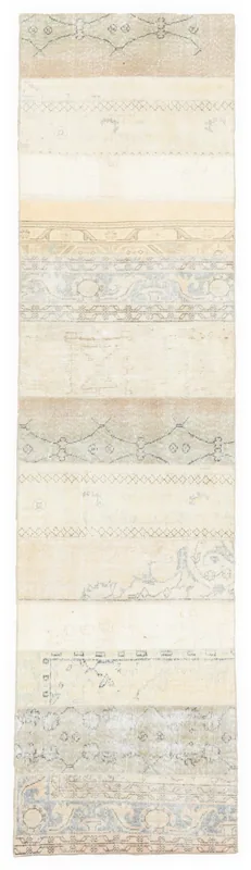Full overhead view of the 2'7" x 10'8" ivory and gray patchwork vintage runner rug