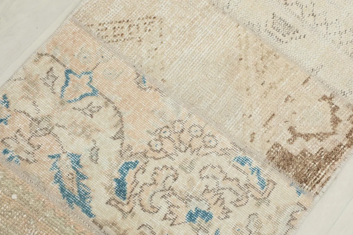 Detailed view of a section of the rug showing blue and beige patterns with visible wool pile.
