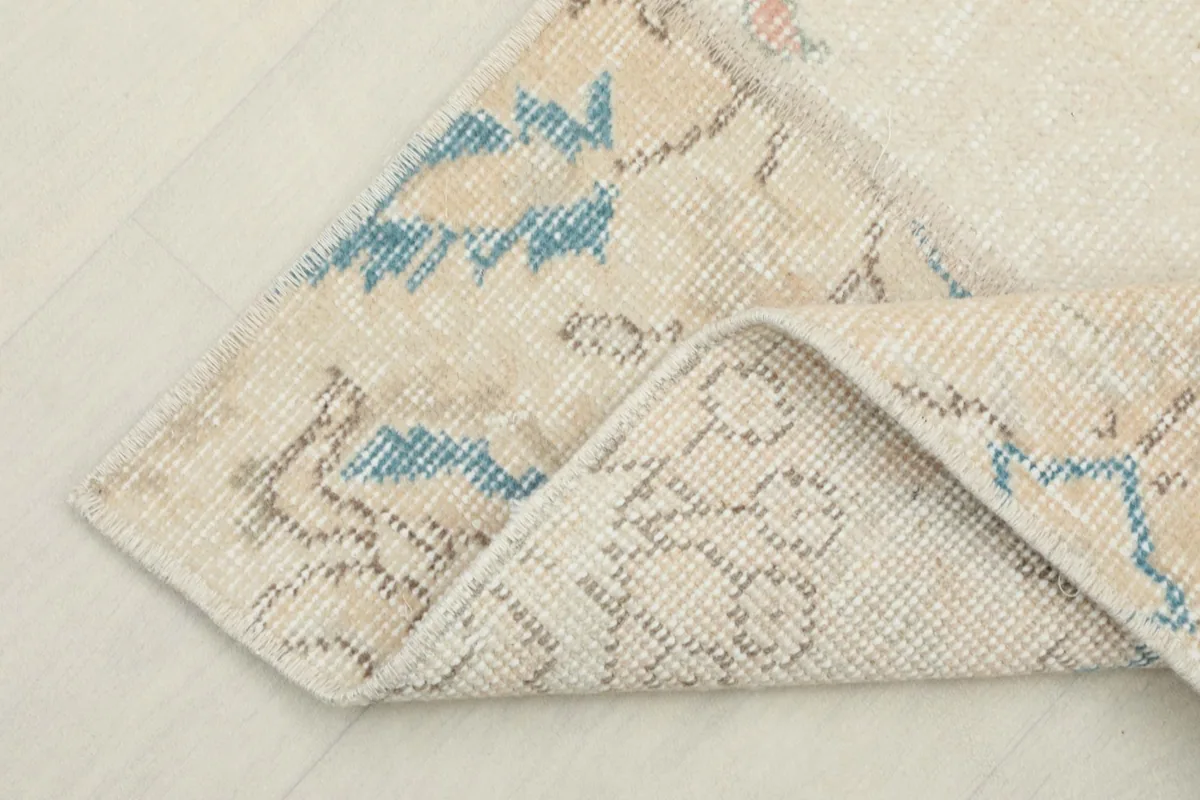 View of the back of the rug, showing the cotton foundation and hand-knotted construction.