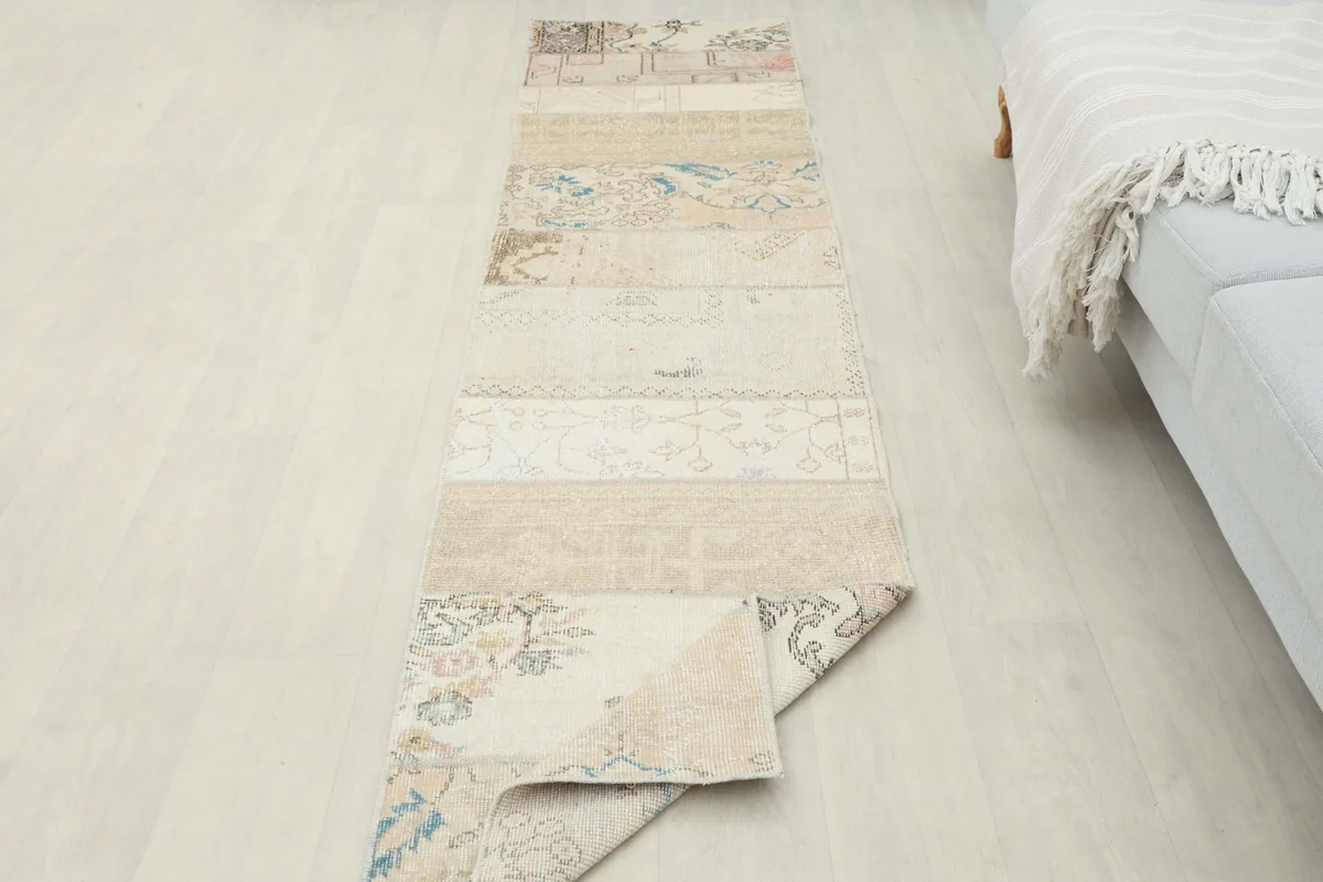 The runner rug with one corner folded back, displaying the back of the rug and the full length.