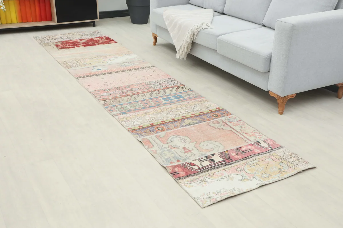 Patchwork runner rug in a room setting, showing its length and design alongside a sofa