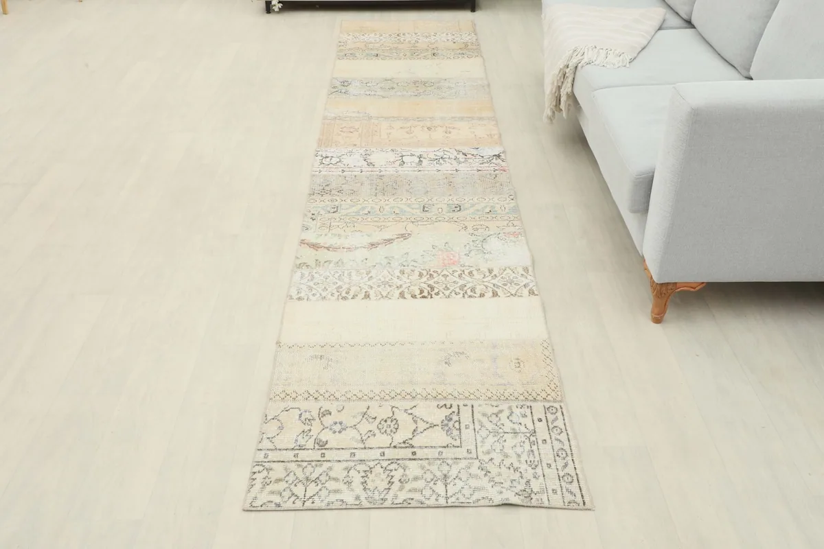 Full overhead view of the vintage runner rug in a room setting, emphasizing its length and design