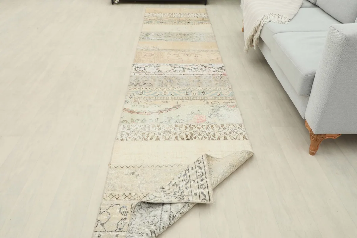 Runner rug with one end slightly folded, displaying the thickness and drape of the wool material