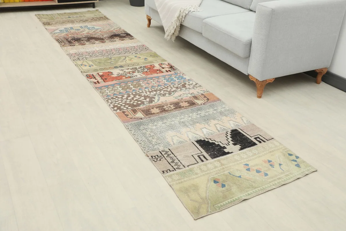 Long view of the vintage runner rug in a hallway setting, showing its length and design