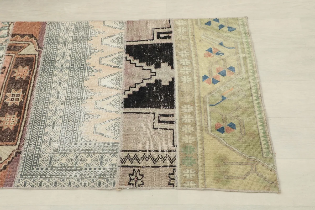 Close-up of the end section of the runner, showing beige, gray, black, and green patchwork segments