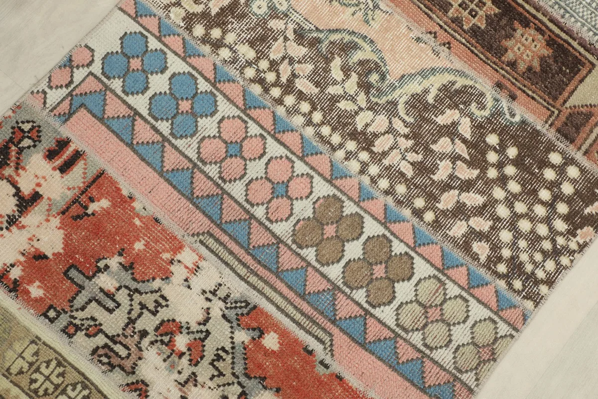 Detailed view of various patchwork sections, including rust, pink, blue, and brown motifs
