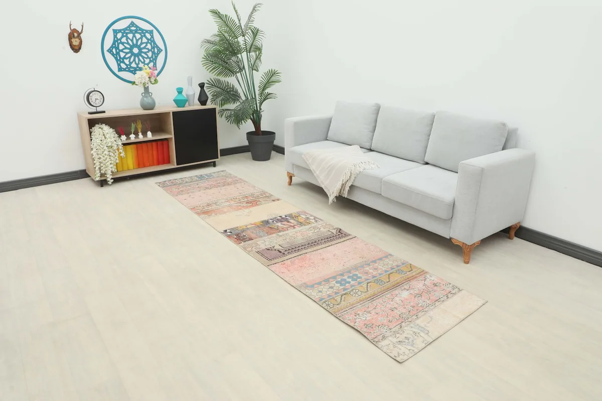 Patchwork runner rug in a modern living space, showing its length and blend of rose, beige, and blue tones