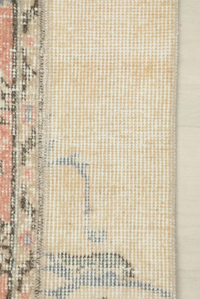 View of the back of the hand-knotted rug, revealing the cotton foundation and construction