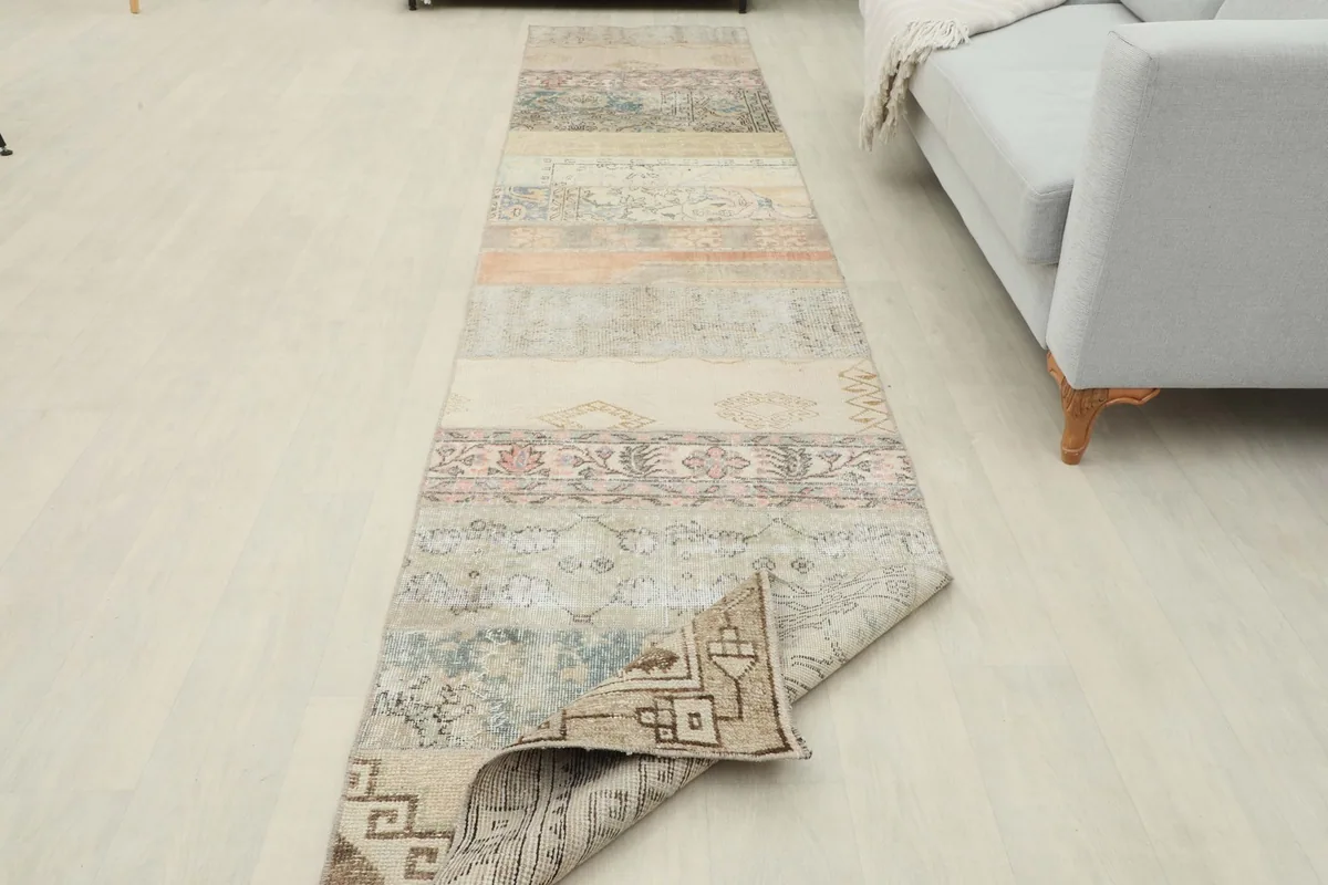 Angled view of the runner rug, showcasing its full length and varied patchwork sections