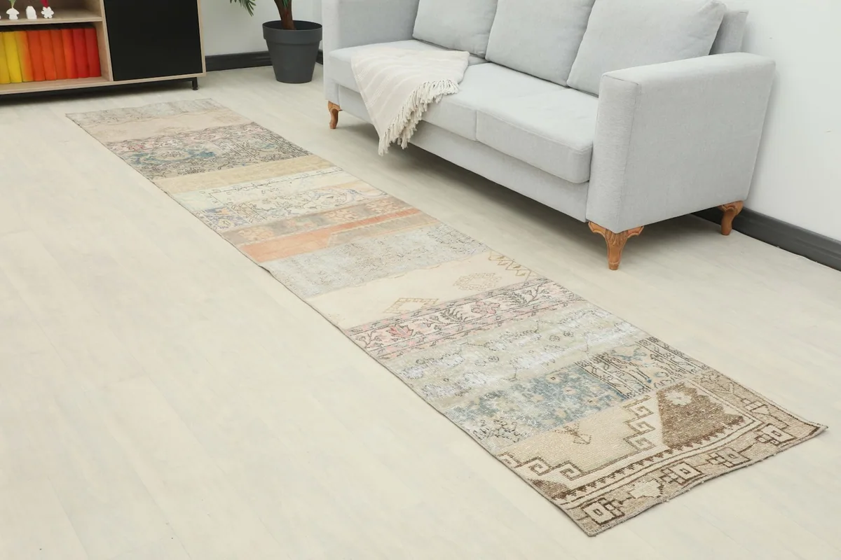 Angled view of the runner rug in a room, showing its length and patchwork design