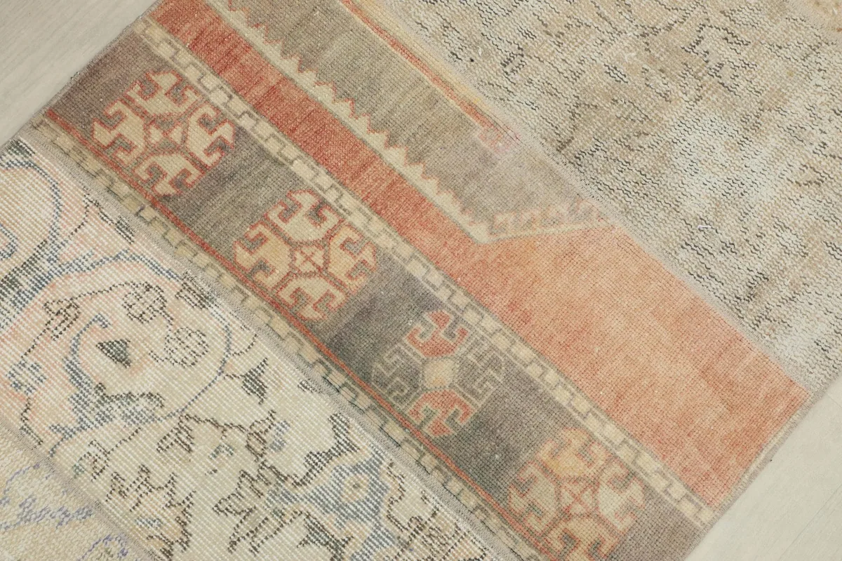 Detail of a rust-colored patchwork section with geometric patterns and muted tones