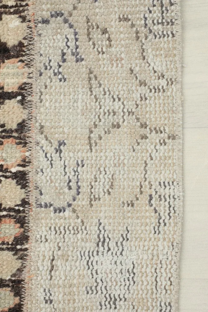 Close-up of a beige and gray patterned patch with subtle texture in the runner rug.