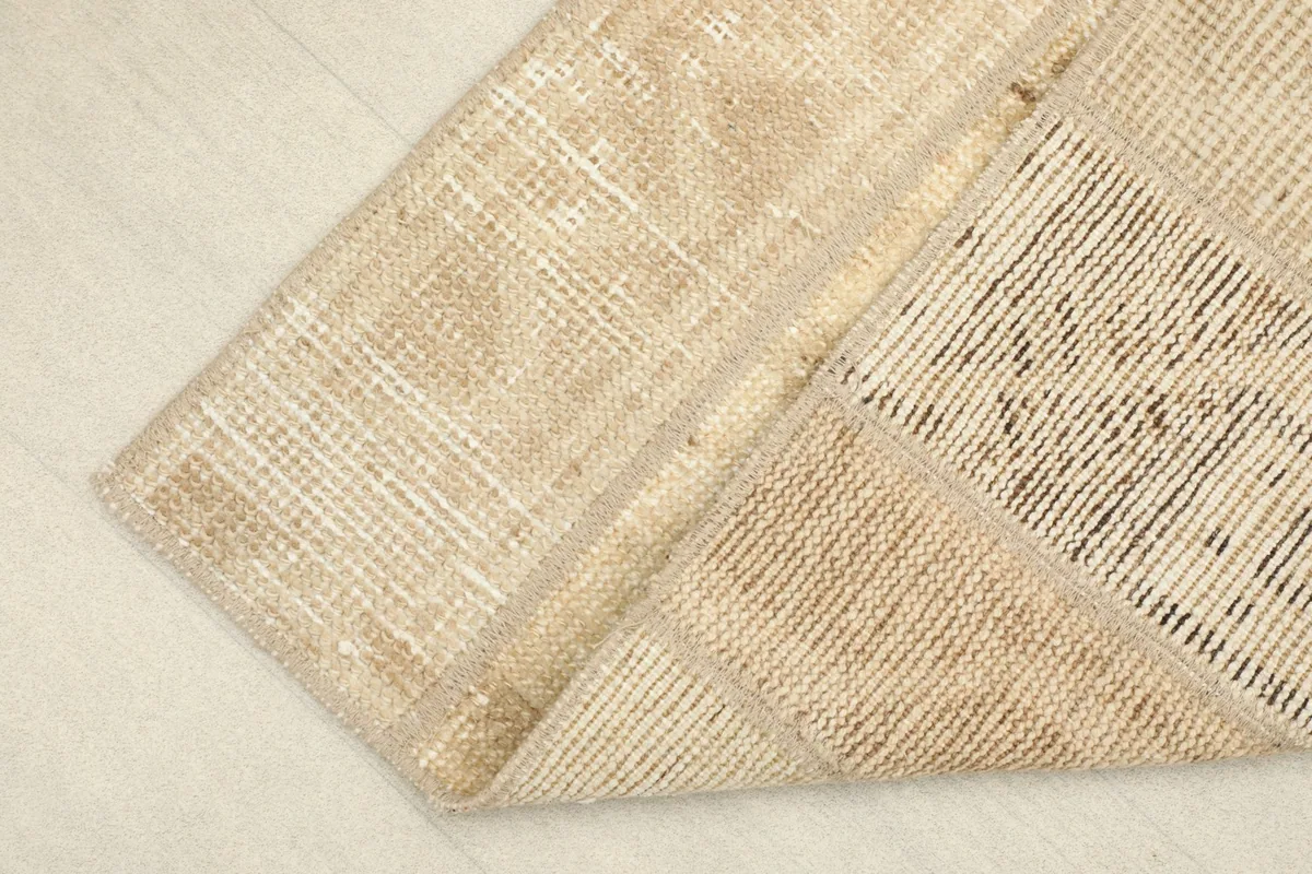 View of the back of the hand-knotted runner, revealing the cotton foundation and knotting.