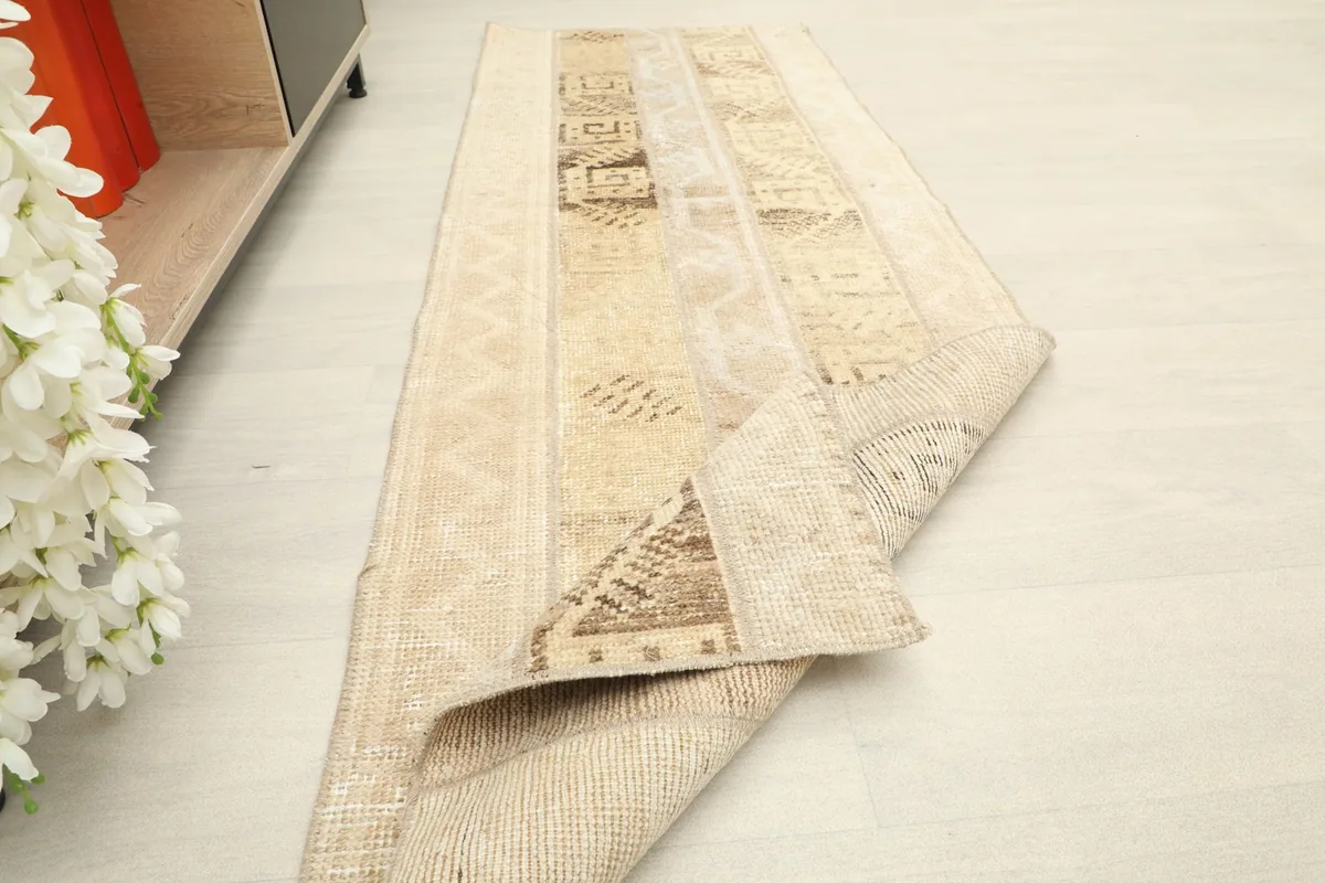 The runner partially folded, showing the flexibility and thickness of the vintage wool.