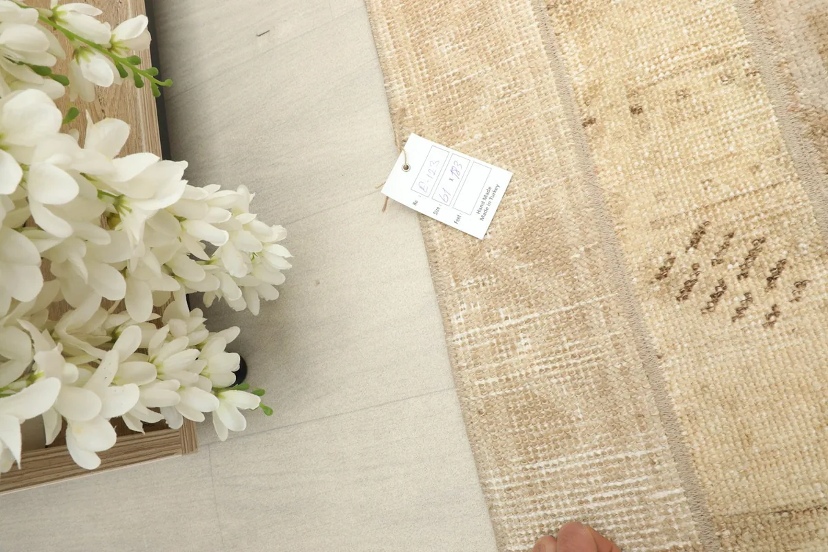 Close view of the rug's texture and a small tag, indicating its quality and origin.