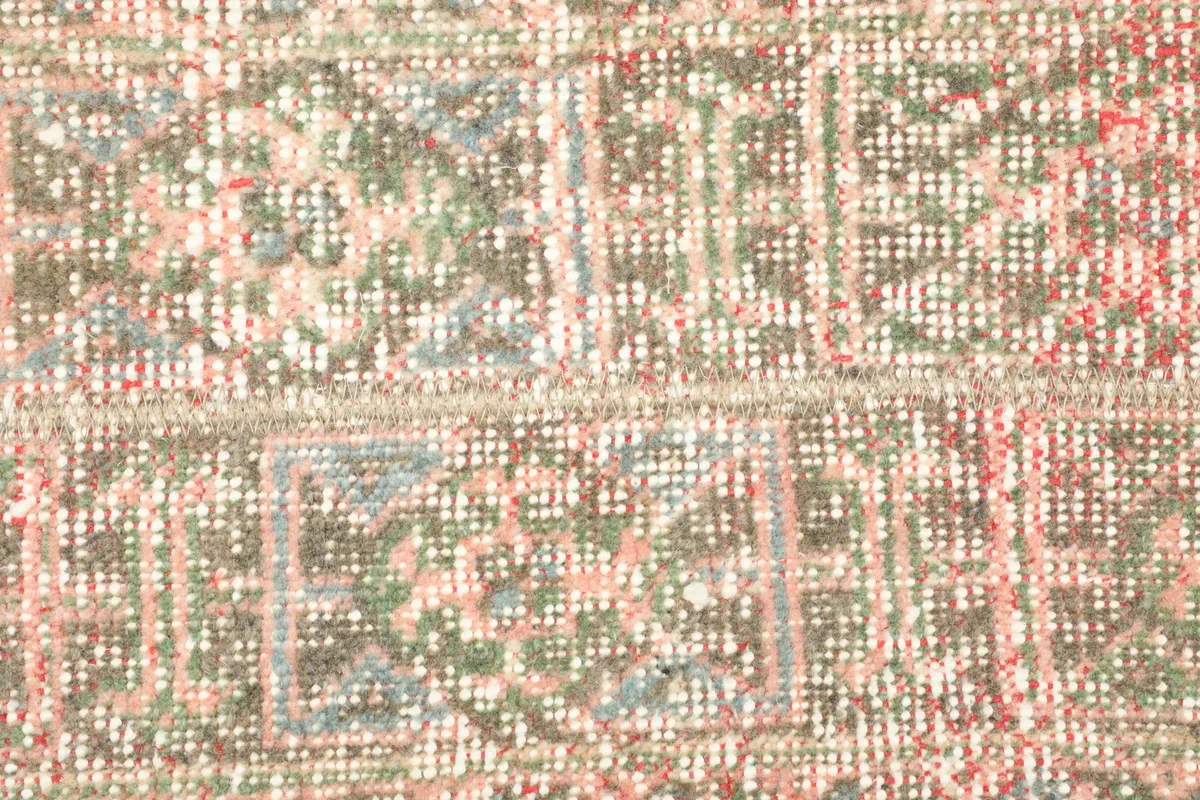 Detailed view of the hand-knotted wool pile, revealing individual knots and the subtle color variations.