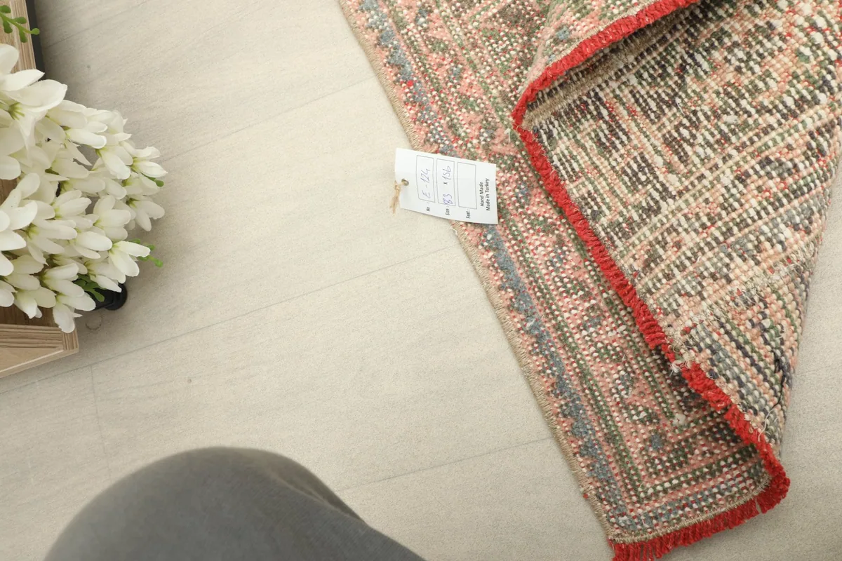 Close-up of the rug's back and corner, with a portion of the tag visible, indicating its origin and material.