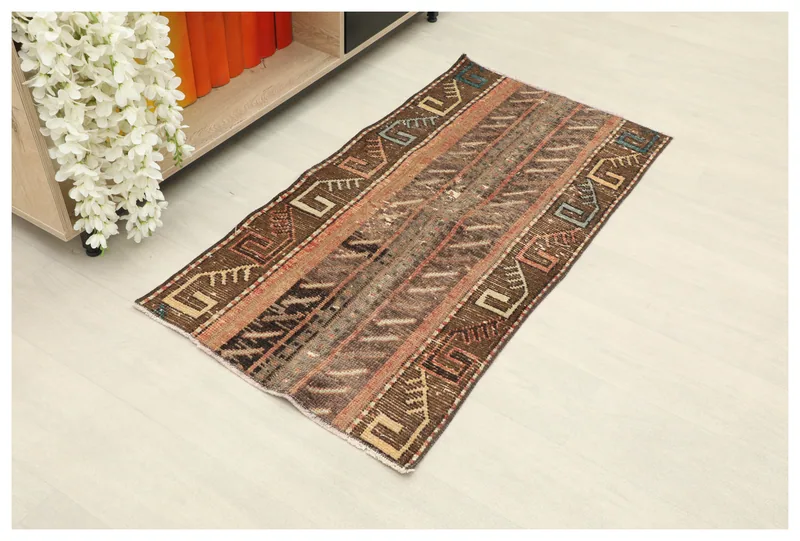 Full top view of the vintage brown geometric area rug on a white background.