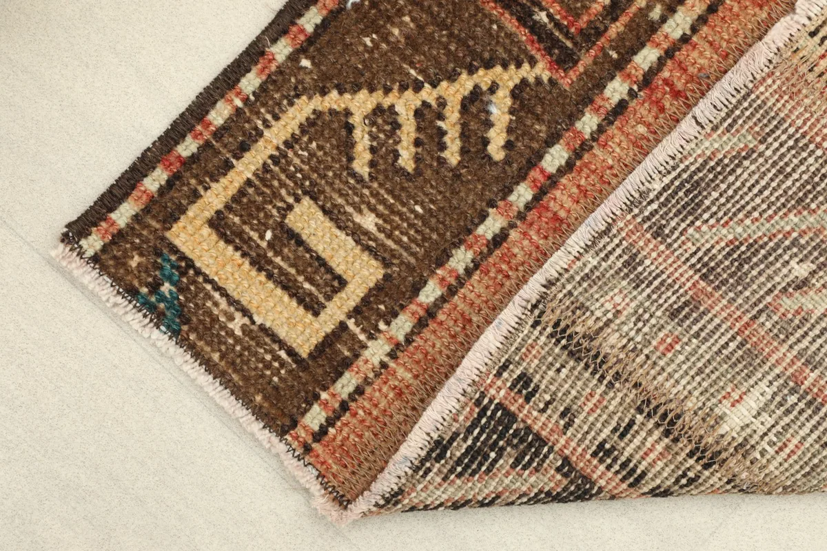 View of the rug's backside, revealing the cotton foundation and hand-knotting.