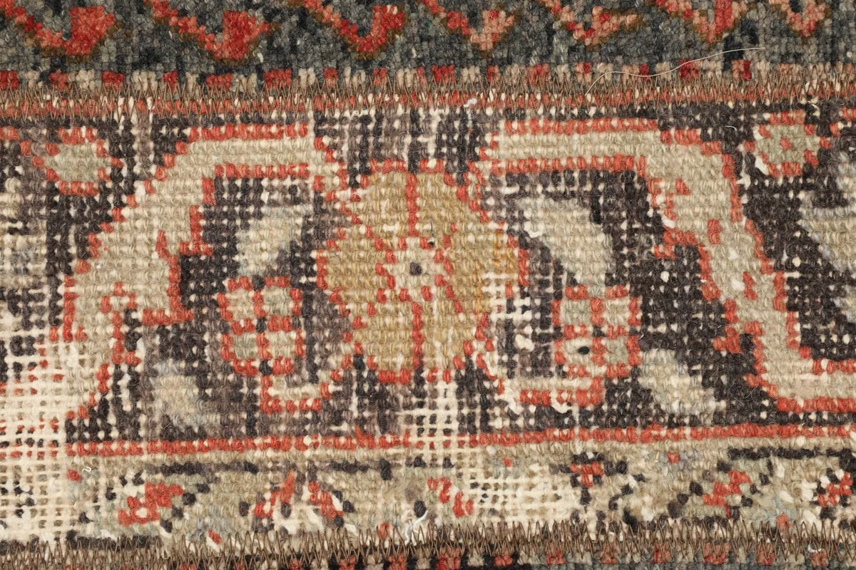 Extreme close-up on a specific geometric motif, revealing the weave and the blended colors of the fibers.