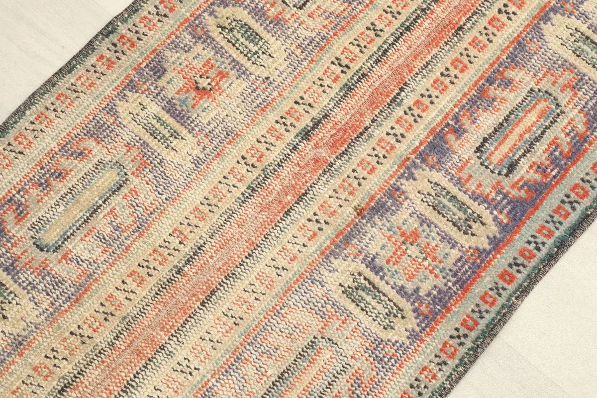 Angled view of the rug, illustrating the subtle color shifts and low pile from one direction.