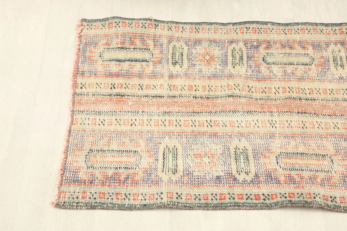 Angled shot showcasing the rug's full width and pattern repeat, from a side perspective.