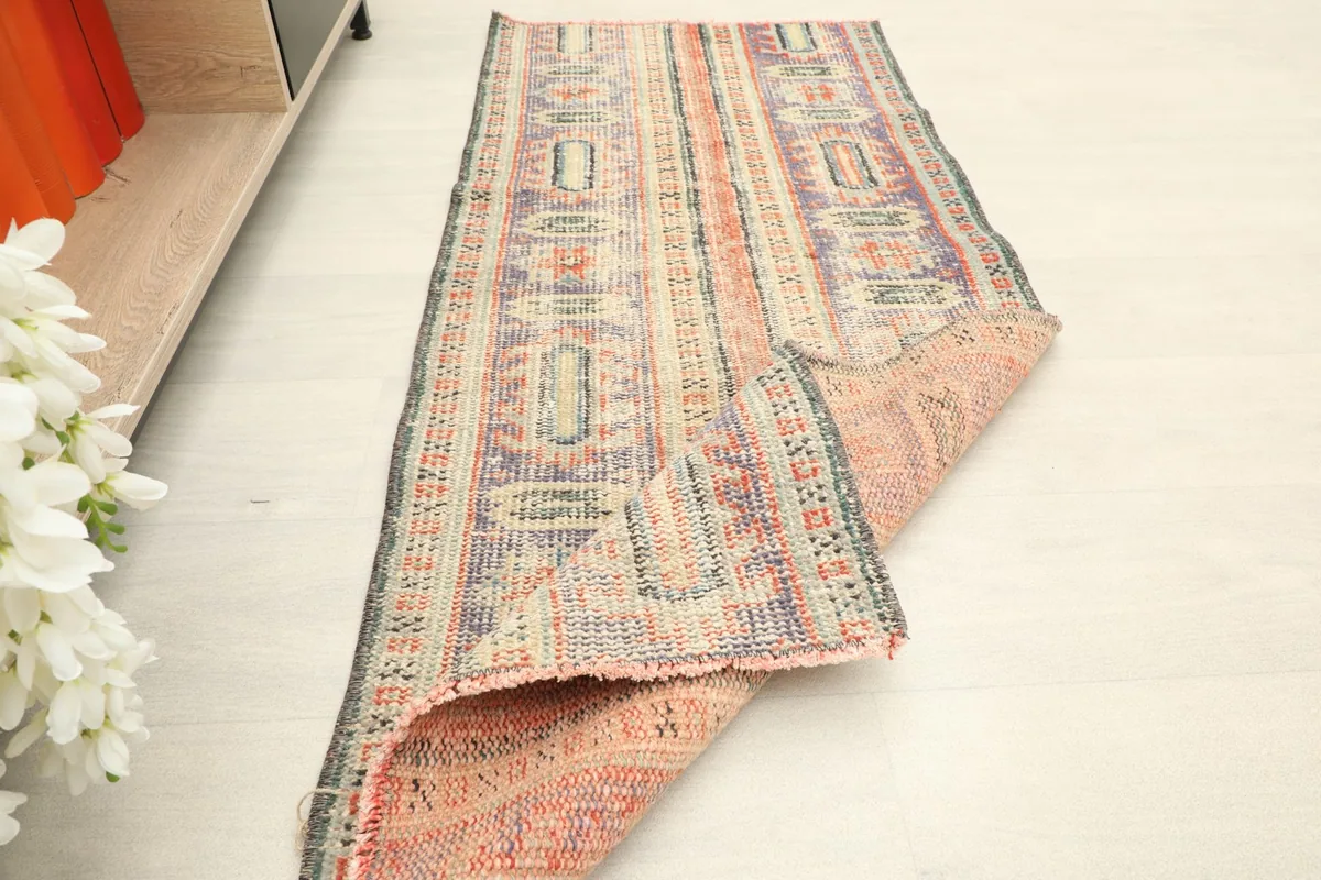 The runner partially folded, demonstrating its flexibility and the reverse side's construction.