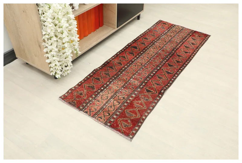 Full top view of the 1'11" x 5'1" vintage red tribal runner rug on a white background.
