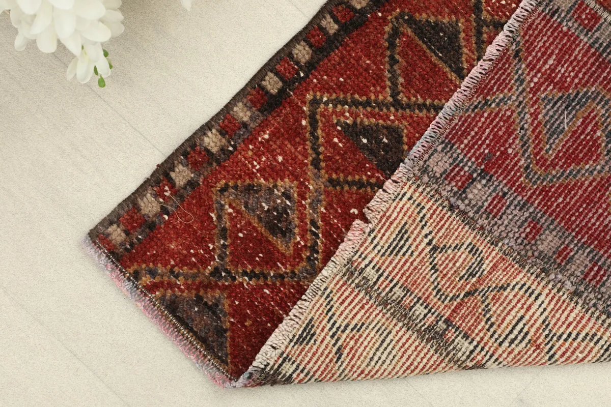 Close-up showing the back of the rug and the reverse side of the hand-knotted cotton foundation.